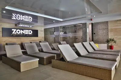 a waiting room with couches and chairs in a store at Zoned MASLAČAK lux - SPA & Wellness Kopaonik in Kopaonik