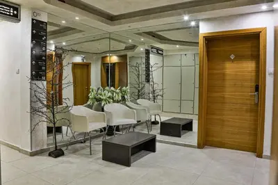 a dining room with a table and white chairs at Zoned MASLAČAK lux - SPA & Wellness Kopaonik in Kopaonik