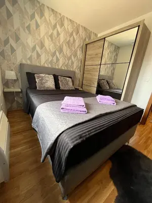 a bedroom with a bed with two towels on it at Apartman Korać in Vrnjačka Banja