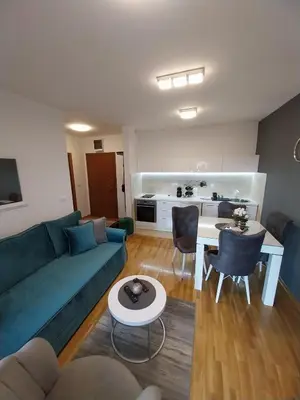 a living room with a couch and a table at Apartman Korać in Vrnjačka Banja
