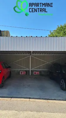 a garage with two cars parked in it at Apartman Sandra Free parkig in Vrnjačka Banja