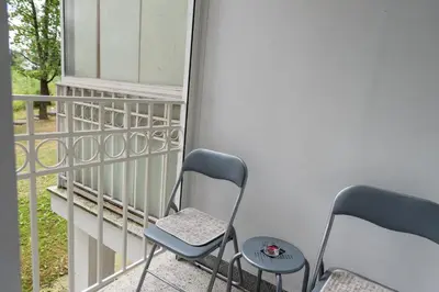 two chairs and a table on a balcony at Apartman Sandra Free parkig in Vrnjačka Banja