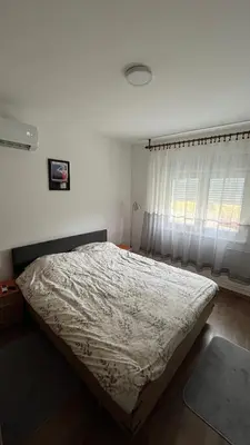 a bedroom with a bed and a window at villa Antonijevic in Brestovac