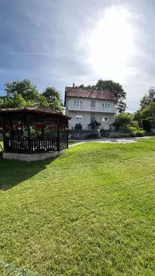 a large house with a gazebo in a field at villa Antonijevic in Brestovac