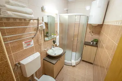 a small bathroom with a toilet and a sink at Zen apartman in Kopaonik
