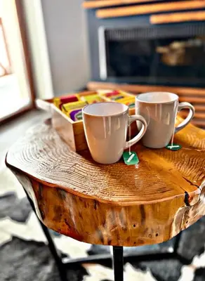 two coffee mugs sitting on a wooden table at Mr Alek - Luxury Apartment Kopaonik in Kopaonik