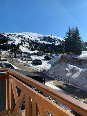 a view of a snow covered parking lot from a deck at Mr Alek - Luxury Apartment Kopaonik in Kopaonik
