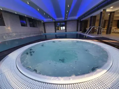 a jacuzzi tub in the middle of a building at Mr Alek - Luxury Apartment Kopaonik in Kopaonik