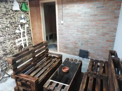 two wooden benches sitting next to a brick wall at Galerija68 in Kraljevo