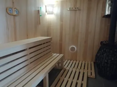 a wooden bench in a sauna with a light at Galerija68 in Kraljevo