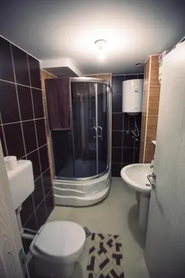 a bathroom with a shower and a toilet and a sink at Aber Apartmani Kopaonik in Kopaonik