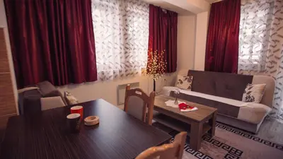 a living room with a couch and a table at Aber Apartmani Kopaonik in Kopaonik