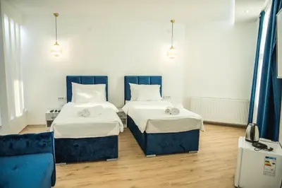 two beds in a room with blue and white at Sky apartmani & spa-Vip Lux DOO in Leskovac