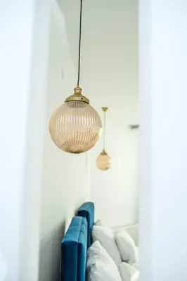 two lights hanging over a couch in a room at Sky apartmani & spa-Vip Lux DOO in Leskovac