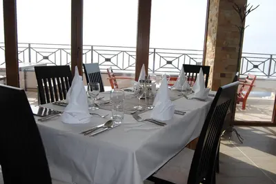 a table with a white table cloth and napkins on it at Milmari - Breakfast and pool in Kopaonik