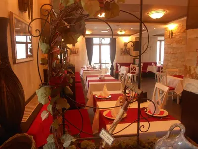 a restaurant with white tables and red and white tables at Milmari - Breakfast and pool in Kopaonik