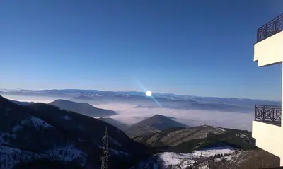 a view of a mountain range with the moon in the sky at Milmari - Breakfast and pool in Kopaonik