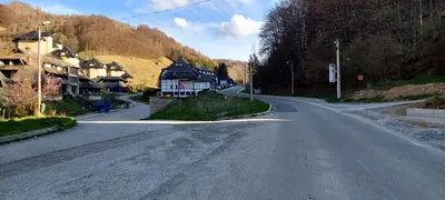 an empty street with houses on the side of a hill at Brzeće Center Studio Mitrovski Gondola 300m in Kopaonik