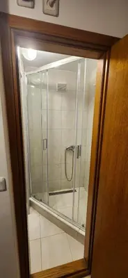 a bathroom with a shower with a glass door at Vila Ivanović in Kopaonik