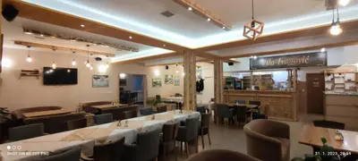 a restaurant with tables and chairs in a room at Vila Ivanović in Kopaonik