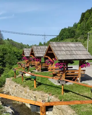 a group of benches in front of a building at Vila Ivanović in Kopaonik