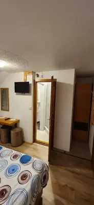 a bedroom with a bed and a sliding glass door at Vila Ivanović in Kopaonik