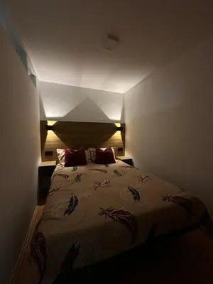 a bedroom with a large bed with red pillows at Čarapan in Kruševac