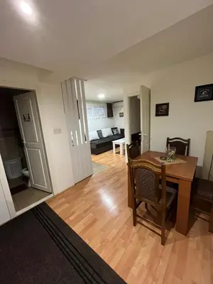 a living room with a table and a dining room at Čarapan in Kruševac