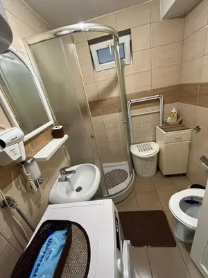 a small bathroom with a shower and a sink at Čarapan in Kruševac