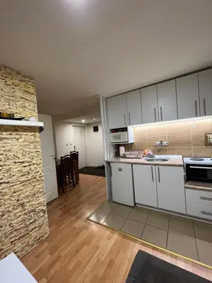 a kitchen with white cabinets and a counter top at Čarapan in Kruševac