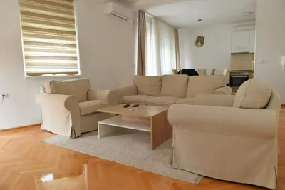 a living room with two couches and a coffee table at Dobi Apartmani WING in Jagodina