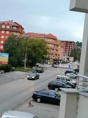 a group of cars parked in a parking lot at Dobi Apartmani WING in Jagodina