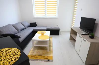 a living room with a couch and a table at Apartmani Gorunović in Soko Banja