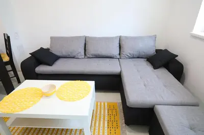 a living room with a couch and a coffee table at Apartmani Gorunović in Soko Banja