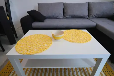 a white coffee table with two circular cushions on it at Apartmani Gorunović in Soko Banja