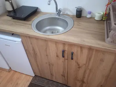 a kitchen counter with a sink on top of it at Mikasa in Niš