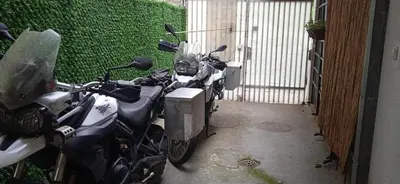 a couple of motorcycles parked next to a garage at Mikasa in Niš