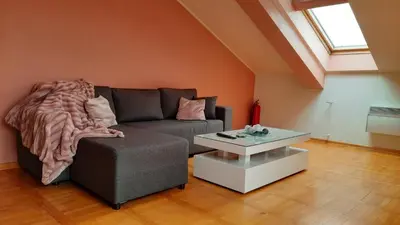 a living room with a couch and a coffee table at Loft apartman in Jagodina