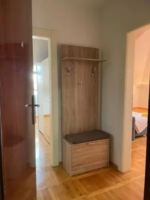 a room with a closet with a bench in it at Loft apartman in Jagodina