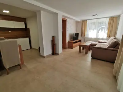 a living room with a couch and a table at Apartmani Tesla in Soko Banja