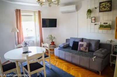 a living room with a couch and a table at Apartman Ristovic in Vrnjačka Banja