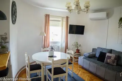 a living room with a table and a couch at Apartman Ristovic in Vrnjačka Banja
