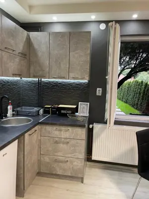 a kitchen with a sink and a counter with a window at Beta House Apartments in Zaječar