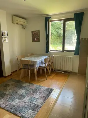 a dining room with a table and chairs and a window at Apartman Djordjevići in Vrnjačka Banja