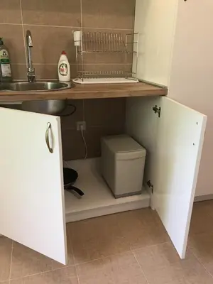 a small kitchen with a sink and a toilet at Apartman Djordjevići in Vrnjačka Banja