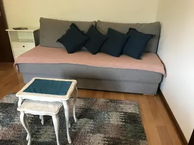 a couch with pillows and a table in a room at Apartman Djordjevići in Vrnjačka Banja