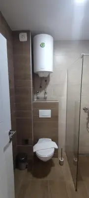 a bathroom with a toilet and a glass shower at Snow peak Wellness & Spa, Kopaonik Milmari N5 in Kopaonik