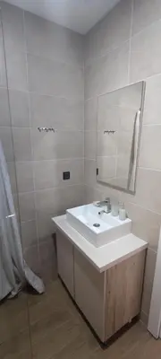a bathroom with a white sink and a mirror at Snow peak Wellness & Spa, Kopaonik Milmari N5 in Kopaonik