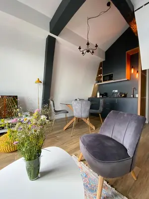a living room with a chair and a table at Apartman L8 Kopaonik in Kopaonik