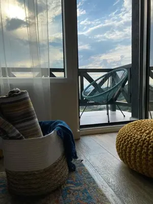 a living room with a chair and a window at Apartman L8 Kopaonik in Kopaonik